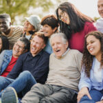Crowd of multiracial people having fun together at city park - Social gathering and community concept